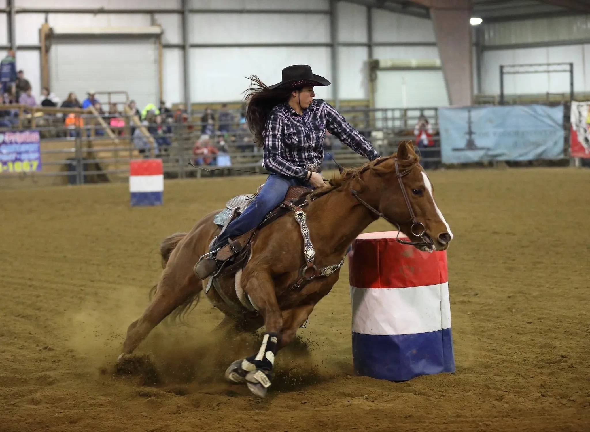 Cowgirl and Horse in Intense Barrel Racing Action
