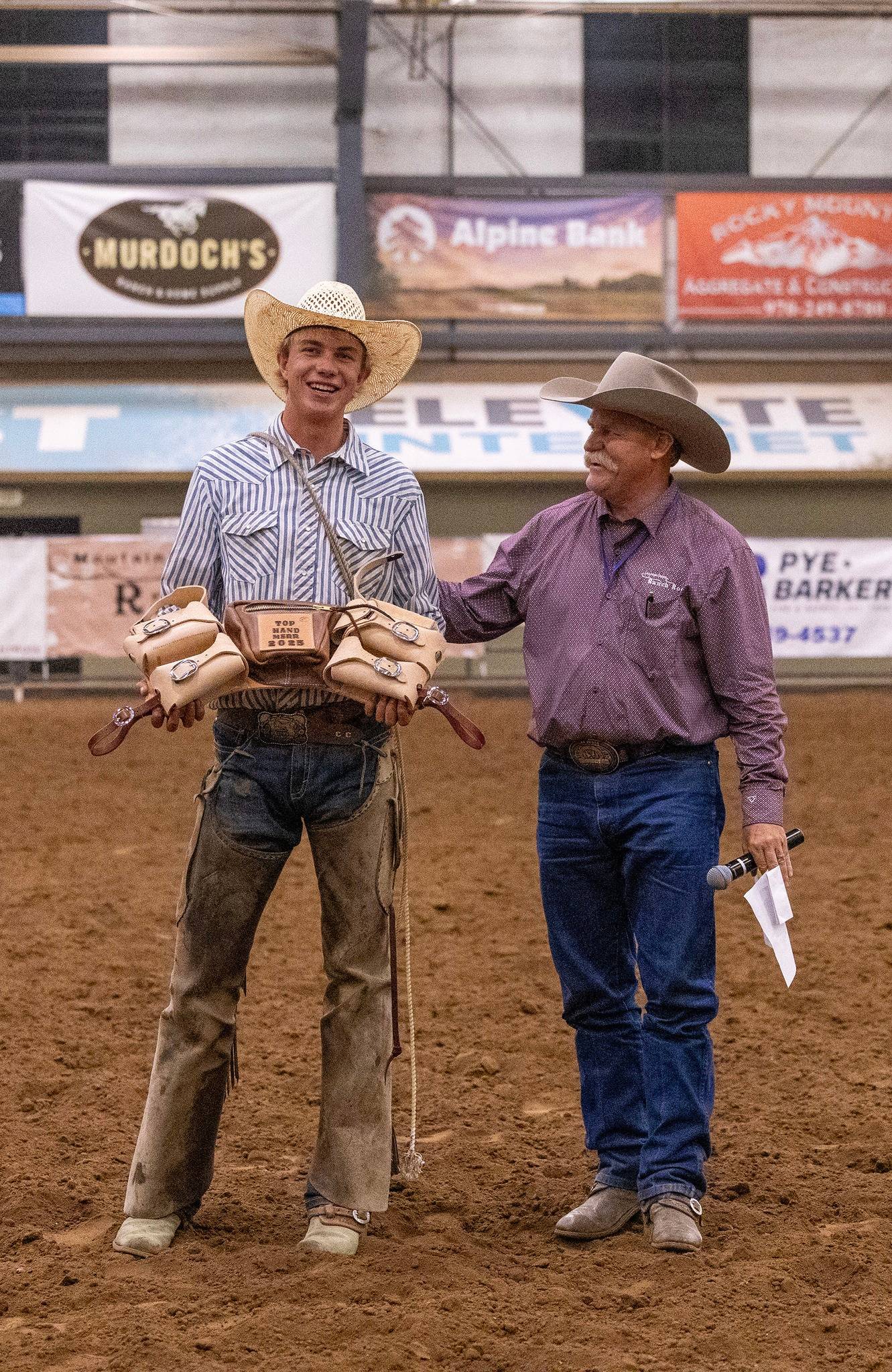 Young Cowboy Receives Award at Indoor Rodeo Event