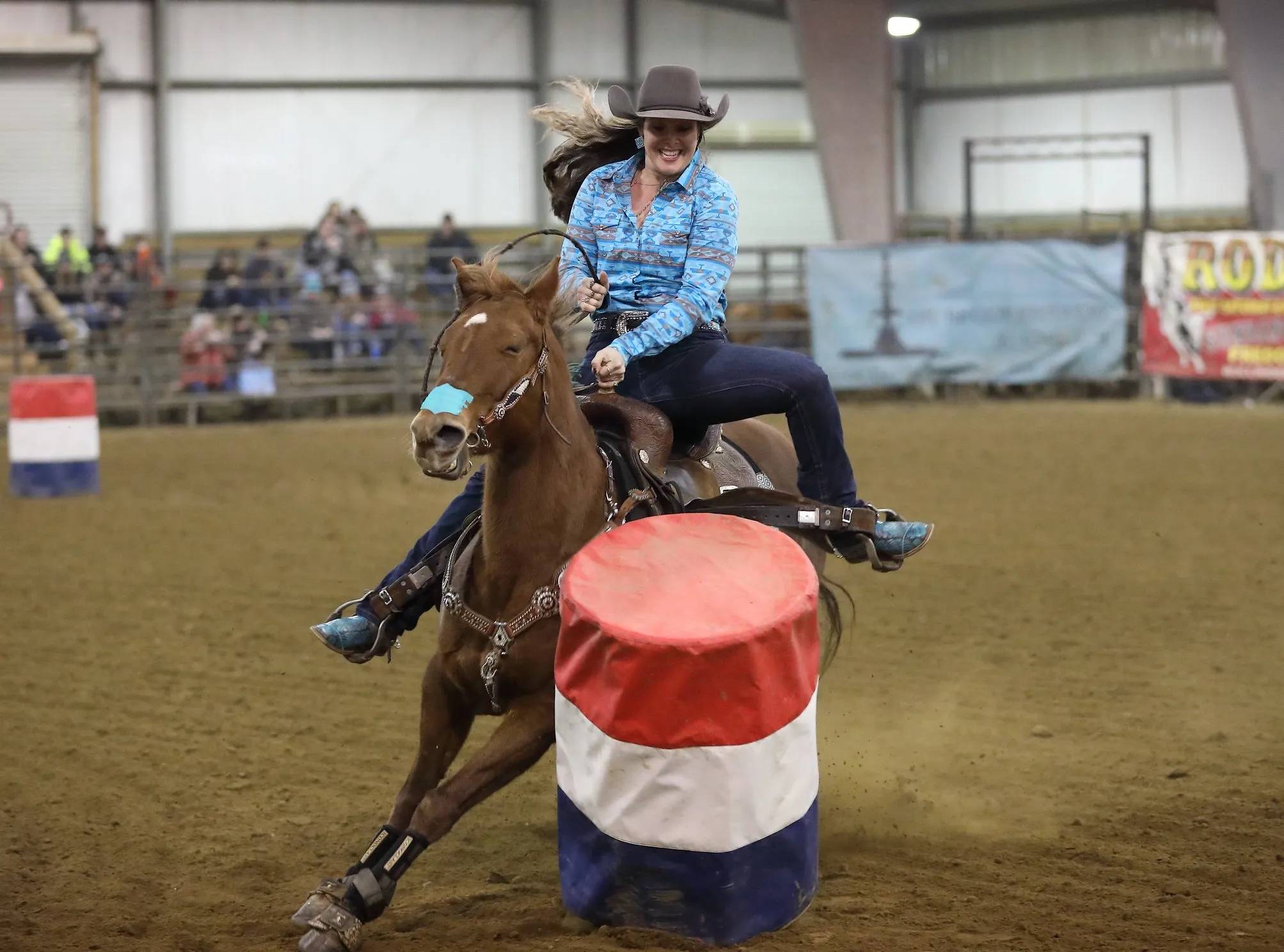 Cowgirl Barrel Racing in Indoor Arena