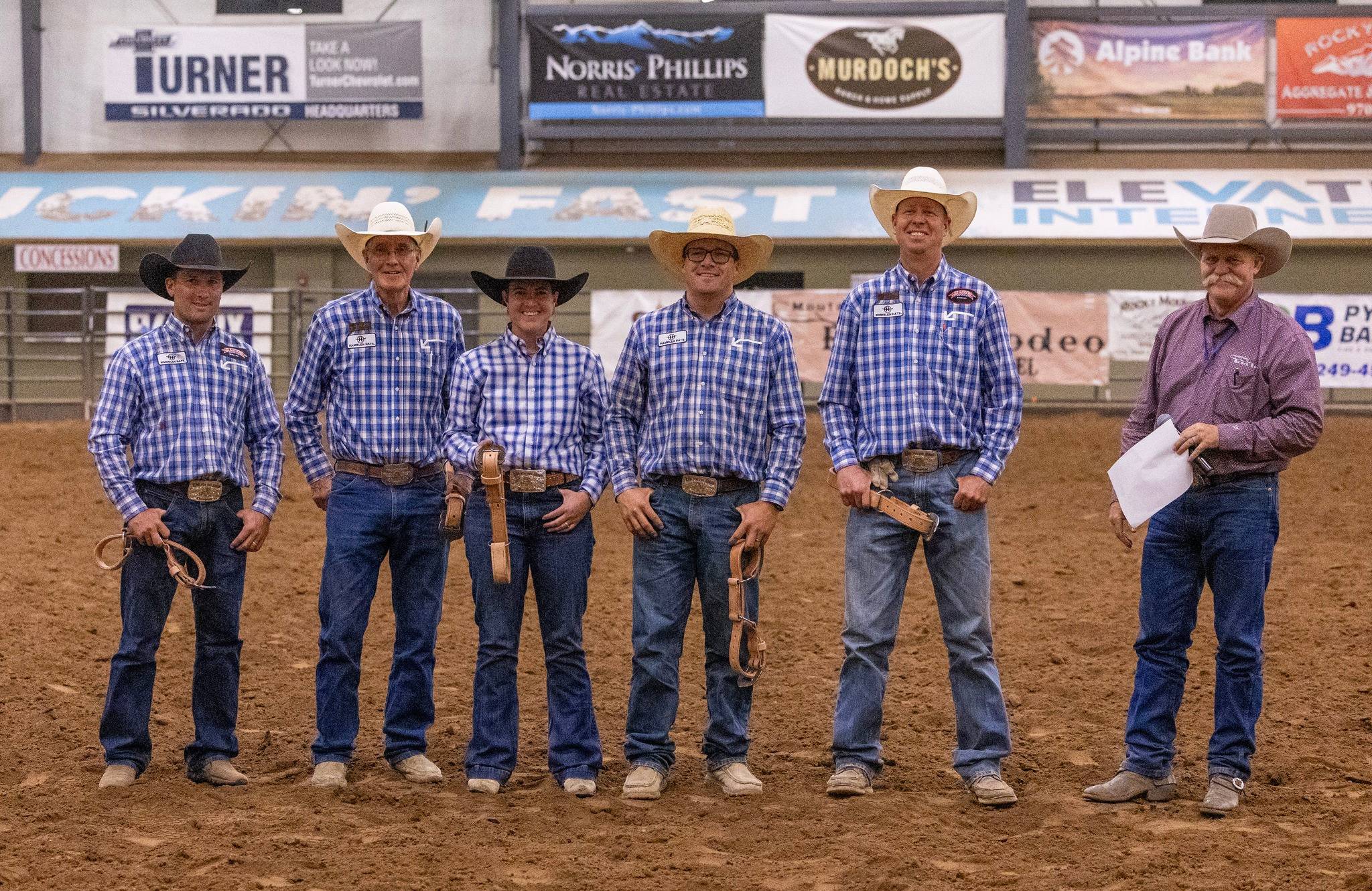 Six Cowboys Posing in an Indoor Rodeo Arena